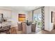 Cozy dining area with a round table, stylish chairs, and a sliding glass door leading to the backyard at 712 Holstein Dairy Way, Wake Forest, NC 27587