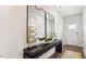 Bright entryway featuring a console table with decor, large mirrors, and a view of the front door at 712 Holstein Dairy Way, Wake Forest, NC 27587