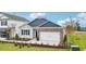 Charming one-story home with brick and gray siding, an attached two-car garage and a well-manicured lawn at 712 Holstein Dairy Way, Wake Forest, NC 27587