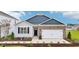 Charming one-story home with brick and gray siding, an attached two-car garage and a well-manicured lawn at 712 Holstein Dairy Way, Wake Forest, NC 27587