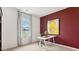 Bright home office with modern decor, large window, and a striking accent wall at 712 Holstein Dairy Way, Wake Forest, NC 27587