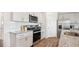 Well-lit kitchen featuring white cabinetry, stainless steel appliances, granite countertops, and a stylish backsplash at 712 Holstein Dairy Way, Wake Forest, NC 27587