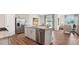 Modern kitchen with stainless steel appliances, granite countertops, an island with seating, and an open layout at 712 Holstein Dairy Way, Wake Forest, NC 27587