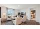Inviting living room with neutral tones, large windows, stylish furniture, and an open doorway to a bedroom at 712 Holstein Dairy Way, Wake Forest, NC 27587