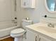 Clean bathroom featuring white vanity, toilet, tub, and shower combination at 7429 Ashbury Ct, Raleigh, NC 27615
