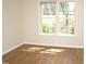 Bright bedroom with hardwood floors and large window providing natural light at 7429 Ashbury Ct, Raleigh, NC 27615