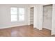Bright bedroom with laminate flooring, a large window, and closets at 7429 Ashbury Ct, Raleigh, NC 27615