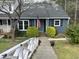 Charming home featuring blue siding, a welcoming front porch, and well-maintained landscaping at 7429 Ashbury Ct, Raleigh, NC 27615