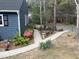Well-maintained front yard with landscaped garden and winding walkway at 7429 Ashbury Ct, Raleigh, NC 27615