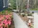 Well-maintained yard featuring lush pink azaleas, bird bath, and mature trees at 7429 Ashbury Ct, Raleigh, NC 27615
