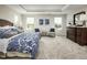 Bright bedroom features tray ceilings, neutral carpet, and ample natural light at 801 Walker Ridge Way, Willow Springs, NC 27592