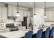 Modern kitchen featuring granite countertops, pendant lights, and stainless steel appliances at 801 Walker Ridge Way, Willow Springs, NC 27592