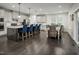 Spacious kitchen and dining area with a large island, dark wood floors, and ample lighting at 801 Walker Ridge Way, Willow Springs, NC 27592
