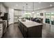 Modern kitchen island featuring granite countertops and pendant lighting at 801 Walker Ridge Way, Willow Springs, NC 27592