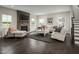 Comfortable living room with a stone fireplace and dark hardwood floors at 801 Walker Ridge Way, Willow Springs, NC 27592