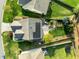 Overhead view of the home with solar panels, a stone patio, landscaped yard, and green space in the neighborhood at 814 Ember Dr, Durham, NC 27703