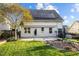 Backyard with solar panels, an outdoor patio, decorative rocks, lush green lawn, and exterior access to the home at 814 Ember Dr, Durham, NC 27703