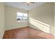Bright bedroom with neutral walls, ceiling fan, and wood-look flooring at 814 Ember Dr, Durham, NC 27703