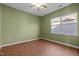 Bright bedroom features wood-look flooring, ceiling fan, and a window at 814 Ember Dr, Durham, NC 27703