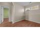 Neutral bedroom with wood-look floors, base molding, and a window at 814 Ember Dr, Durham, NC 27703