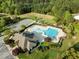 Aerial view of the community pool, amenities, landscaping, nearby green space and parking area at 814 Ember Dr, Durham, NC 27703