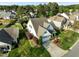 Aerial shot of a beautiful home showcasing landscaping, mature trees, and a well-maintained lawn in a suburban setting at 814 Ember Dr, Durham, NC 27703