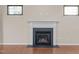 Elegant fireplace with white mantle and black hearth, framed by two windows at 814 Ember Dr, Durham, NC 27703