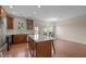 Bright kitchen features an island with quartz countertop, stainless steel appliances, and hardwood floors at 814 Ember Dr, Durham, NC 27703
