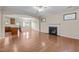 Cozy living room featuring a fireplace, hardwood floors, and an archway leading to the kitchen at 814 Ember Dr, Durham, NC 27703