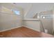 Open loft area with hardwood floors, natural light, and view of the staircase at 814 Ember Dr, Durham, NC 27703