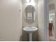 Powder room features a pedestal sink, an oval mirror, and neutral wall color at 814 Ember Dr, Durham, NC 27703