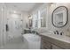 Spa-like bathroom with freestanding tub, walk-in shower, double vanity, and natural light at 818 St Charles St, Durham, NC 27713