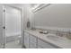 Bright bathroom features a double vanity with stone countertops and a separate tub with white tiling at 818 St Charles St, Durham, NC 27713