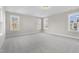 Bright bedroom with neutral walls, carpet, and multiple windows allowing ample natural light at 818 St Charles St, Durham, NC 27713