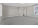 Spacious bedroom with neutral walls, carpet, and view of the entrance to the ensuite bathroom at 818 St Charles St, Durham, NC 27713