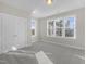Bedroom with closet, neutral walls, carpet, and multiple windows allowing ample natural light at 818 St Charles St, Durham, NC 27713
