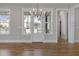 Elegant dining area with hardwood floors, modern chandelier, and large windows for ample natural light at 818 St Charles St, Durham, NC 27713