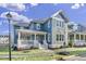 Charming blue two-story home with a welcoming front porch and beautifully landscaped yard at 818 St Charles St, Durham, NC 27713