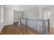 A well lit hallway features hardwood floors, staircase and large windows at 818 St Charles St, Durham, NC 27713