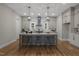 A spacious kitchen features an island with bar seating, modern pendant lighting, and stainless steel appliances at 818 St Charles St, Durham, NC 27713