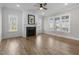 Bright living room featuring a fireplace, hardwood floors, and ample natural light from the windows at 818 St Charles St, Durham, NC 27713