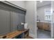 Mudroom with a sitting bench, cabinets, and view of the attached laundry room at 818 St Charles St, Durham, NC 27713