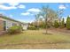 Spacious backyard with healthy grass, landscaping, and a tree at 830 Finnbar Dr, Cary, NC 27519