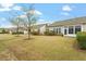 Expansive backyard featuring green grass, mature trees, and partial privacy fence at 830 Finnbar Dr, Cary, NC 27519