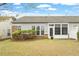 Well-maintained backyard with a patio, lush greenery, and partial fence at 830 Finnbar Dr, Cary, NC 27519