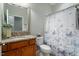 Cozy bathroom featuring granite countertops and a butterfly-themed shower curtain, adding a touch of charm at 830 Finnbar Dr, Cary, NC 27519