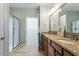 Well-lit bathroom featuring double sinks, granite countertops, and a glass-enclosed shower, designed for comfort at 830 Finnbar Dr, Cary, NC 27519