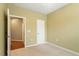 Carpeted bedroom featuring neutral tones, a window, and easy access to adjacent rooms, providing a versatile space at 830 Finnbar Dr, Cary, NC 27519