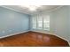 Bright, open bedroom featuring hardwood floors, offering a clean and spacious atmosphere at 830 Finnbar Dr, Cary, NC 27519