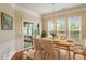 Elegant dining room with wood floors, stylish chandelier, and sliding glass doors that lead to a patio at 830 Finnbar Dr, Cary, NC 27519